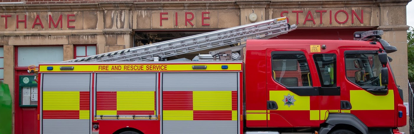 A fire and rescue appliance parked outside a fire station
